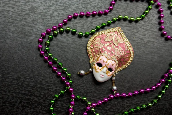 Pink and golden Mask  on a wooden surface