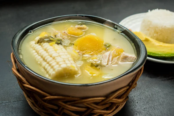Mısır, patates ve diğer farklı sebzelerden oluşan lezzetli Kolombiya çorbası pilav ve avokado parçaları.