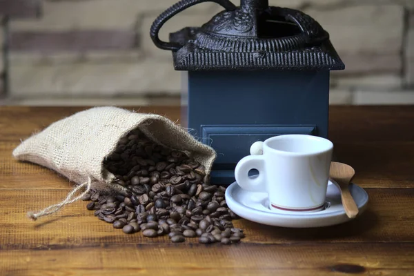 coffee sack, with espresso coffee and an old blue grinder