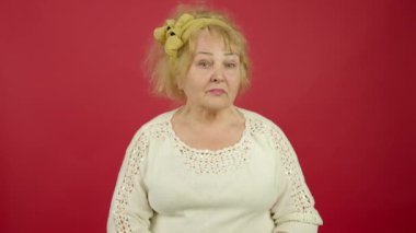 Aşırı kilolu yaşlı bir kadının atık jesti göstermesi