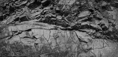  Siyah beyaz arka plan. Volumetrik siyah taş arka plan. 3 boyutlu etki. Kaya dokusu. Taş duvar. Granit bir dağın eski yıpranmış yüzeyi. Yıpranmış eski granit dağ. Kırık taş yüzeyi.                         