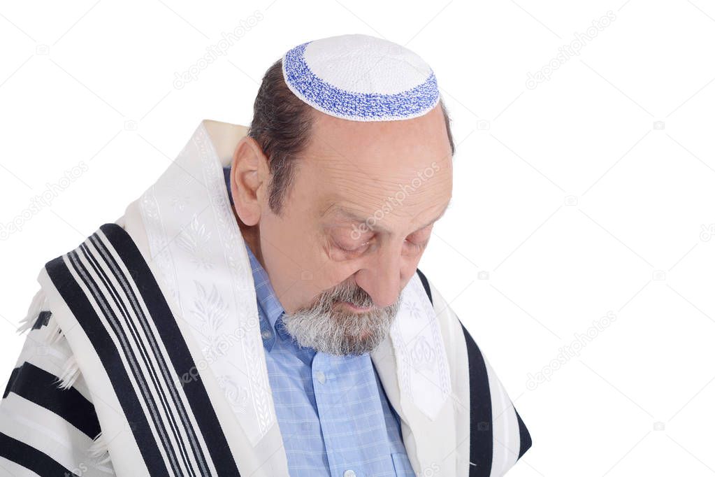 Eldery jewish man with kippah and wrapped in talit praying. Religion concept. Isolated white background