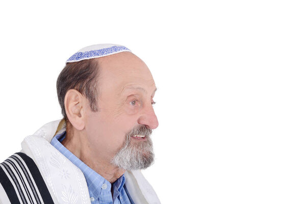 Eldery jewish man with kippah and wrapped in talit praying. Religion concept. Isolated white background
