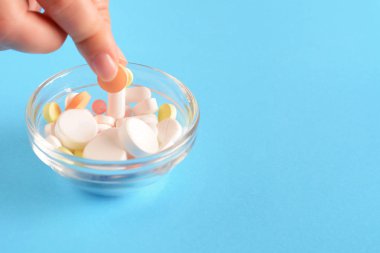 Renkli hapları kase görünümünü kapatın. Mavi arka plan