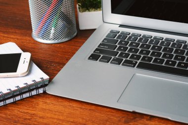 Ahşap masa üzerinde klavye ve telefon ile siyah ekran görünümünü kapatın. Teknoloji kavramı