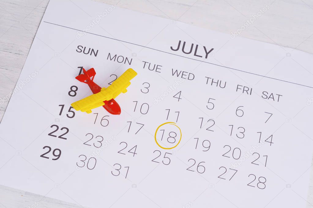 Summer Calendar Schedule, with toy airplane. Travel, tourism, holiday concept.