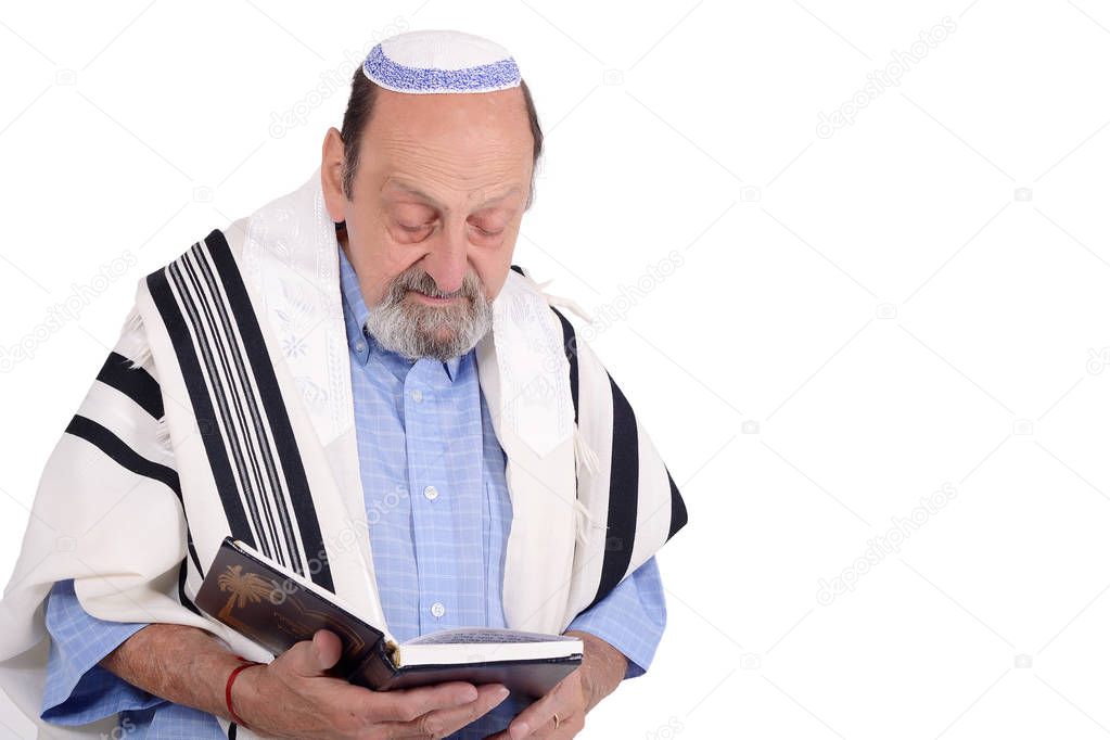Eldery jewish man with kippah and wrapped in talit praying. Religion concept. Isolated white background