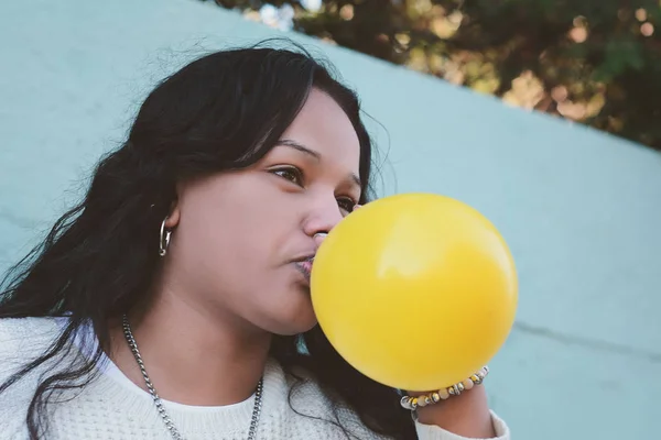 年轻的拉丁妇女的画像是吹气球 — 图库照片