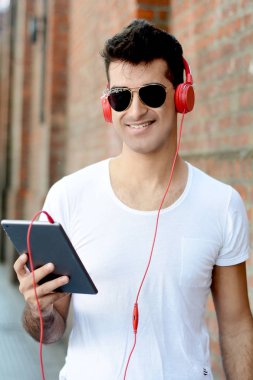 Genç latin adam tablet Street, çok dokunaklı. Kentsel kavramı.