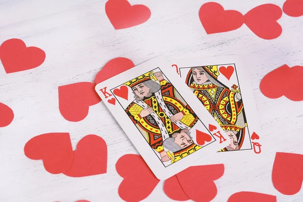 King and Queen of hearts over red hearts shapes. Valentine\'s Day concept