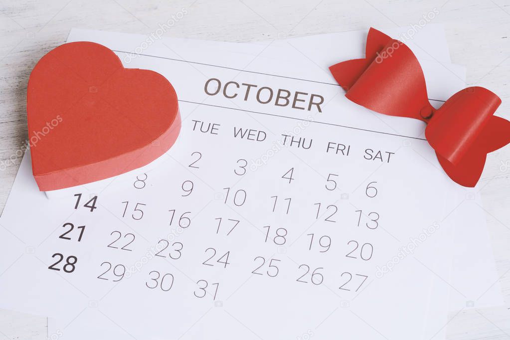 October calendar with red gift box. Date Night, love concept.