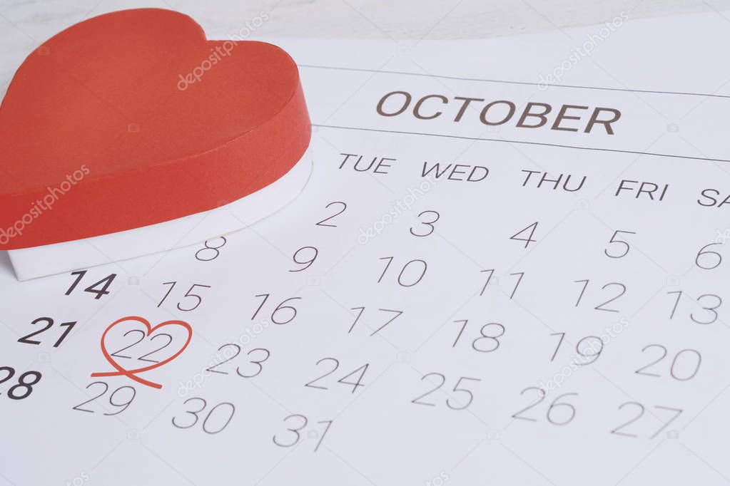 October calendar with red gift box. Date Night, love concept.