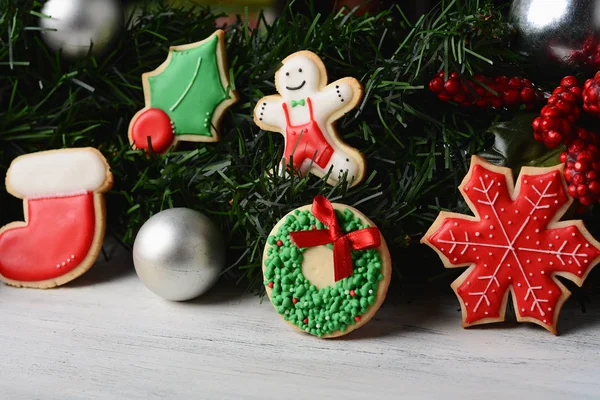 Zbliżenie Christmas Cookies Wiszące Pod Uroczysty Gałęzie Jodły Drewnianym Stole — Zdjęcie stockowe