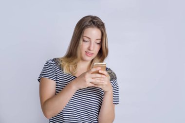 Stüdyo çekim onun akıllı telefon kullanan genç güzel kadın.