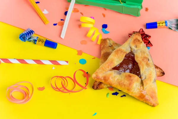 Top view of Purim background with party costume and hamantaschen cookies. Purim celebration concept