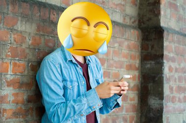 Bir akıllı telefon kullanan Emoji baş adam. Emoji kavramı