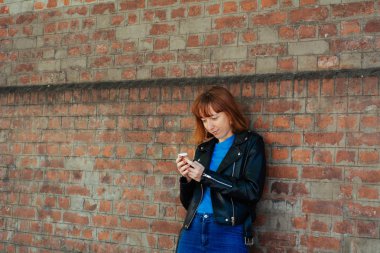 Kızıl saçlı kadın smartphone ileti gönderme.