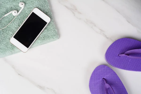 Smartphone, flip-flops and towel.