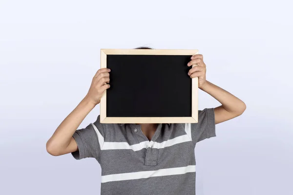 Little boy holding chalkboard. — Stock Photo, Image