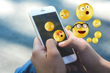 Emojis gönderme smartphone kullanan kadın.