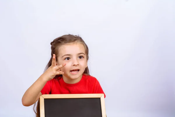 Menina segurando quadro . — Fotografia de Stock