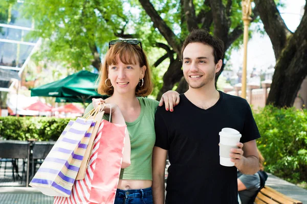 Casal com sacos de compras andando nas ruas . — Fotografia de Stock