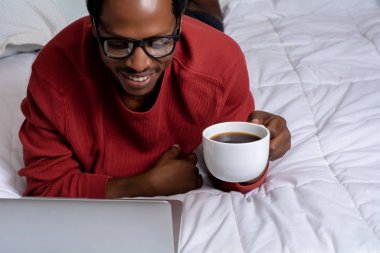 Yatakta onun laptop kullanan genç adam