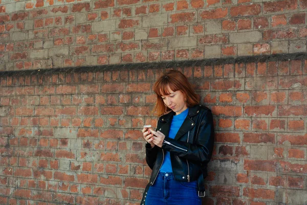 Ruda kobieta wysyłanie wiadomości ze smartfonem. — Zdjęcie stockowe