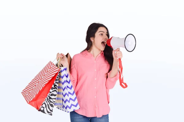 Kobieta trzymająca torby na zakupy i megafon — Zdjęcie stockowe