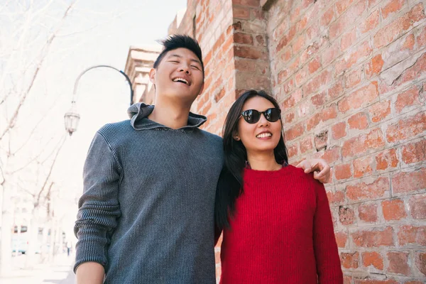 Portrait of young Asian couple in love walking in the city and having good time together. Love concept.