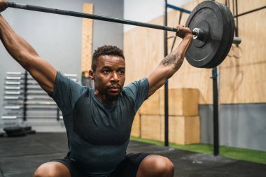 Halterle egzersiz yapan genç çapraz formda sporcunun portresi. Crossfit, spor ve sağlıklı yaşam tarzı konsepti.