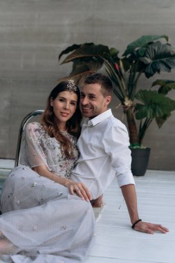 yakışıklı adam ve genç kadın yüzme havuzunda oturan ve kameraya bakarak 