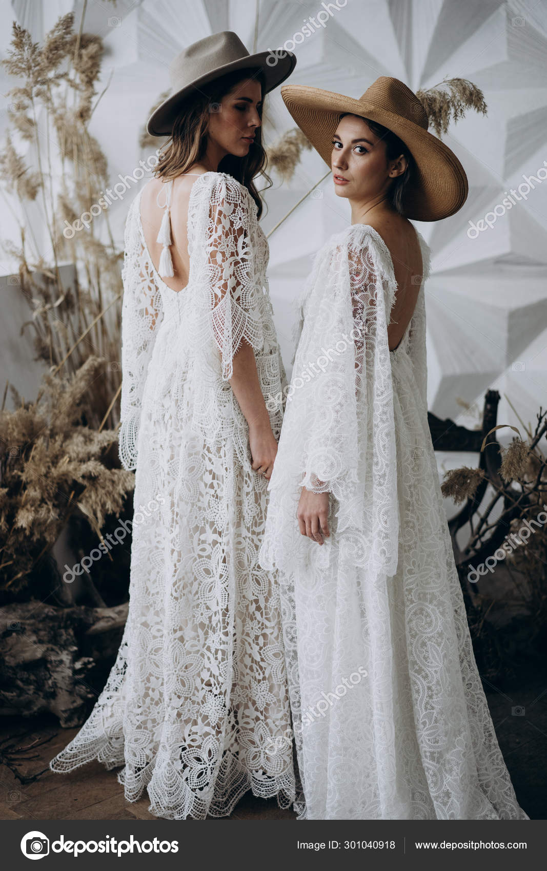 Two Stylish Women Wearing White Dresses Fedora Hats Posing Studio