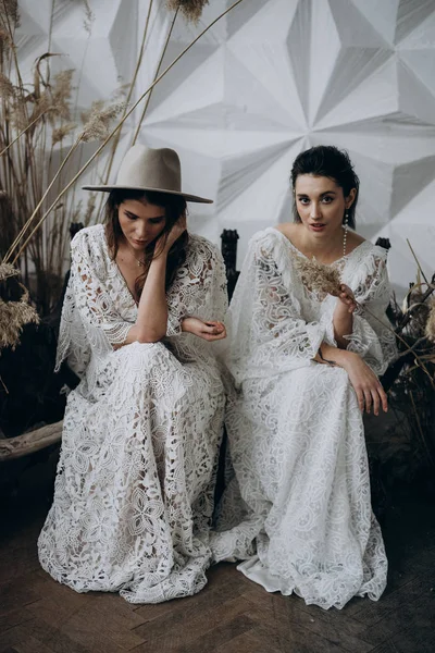 Deux Modèles Robes Blanches Assis Sur Banc Bois Dans Studio — Photo