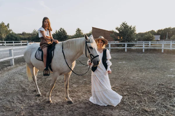 Cheerful Daughter Riding Horse While Mother Holding Bridle Walking Ranch — Stock Photo, Image