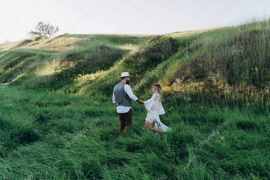 beautiful woman in white dress with handsome man walking in the park