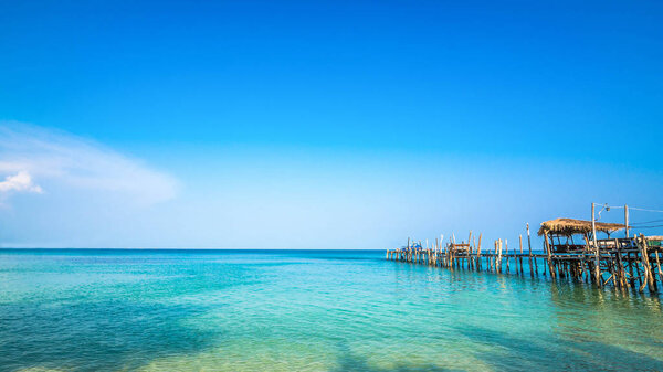 Old wooden pier in Clear water and beautiful bay on Samet Island, Rayong, Thailand.