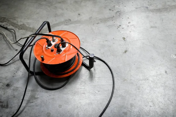 Cable Reel Orange Color Plugged Black Cable Wire Placed Floor Royalty Free Stock Photos