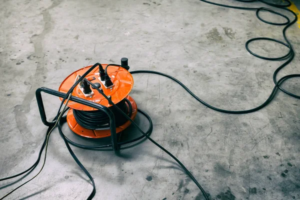 Cable Reel Orange Color Plugged Black Cable Wire Placed Floor Royalty Free Stock Images