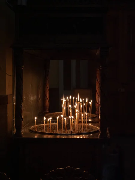 Votive candles alight in Greek Orthodox Church