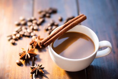 Kahve tarçın çubuğu, Yıldız anason ve kavrulmuş kahve çekirdeği üzerinde ahşap masa, sıcak içecek