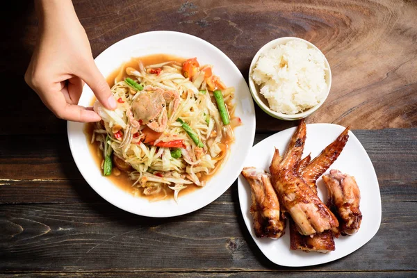 Spicy papaya salad and grilled chicken wing, Thai food (Som Tum)