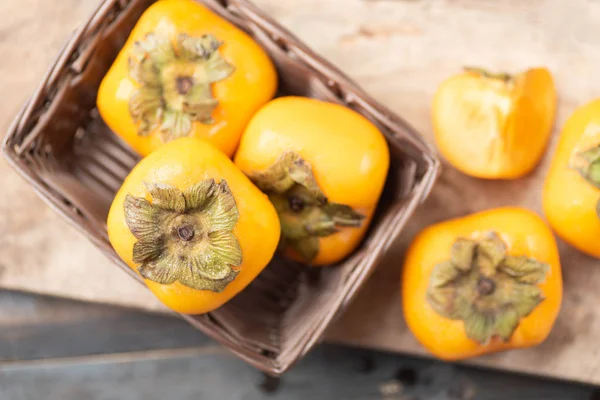 Ripe Persimmon Fruit Basket Wooden Background Top View — Stock Photo, Image