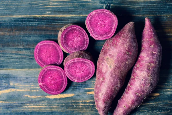 Purple batatas en madera — Foto de Stock