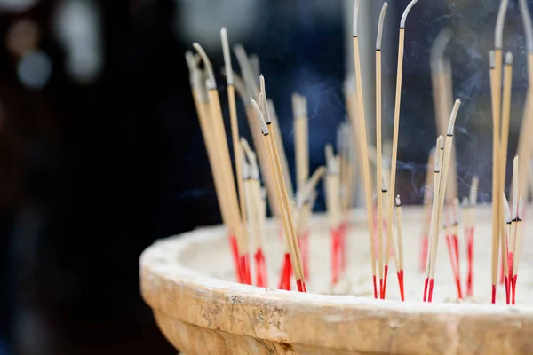 Incense sticks burning in old pot