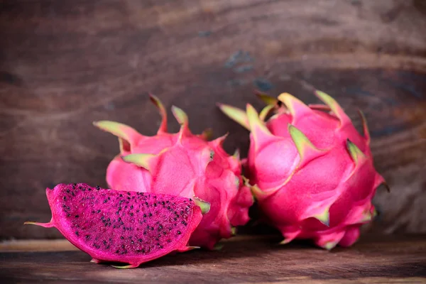 Red dragon fruit on wooden background, tropical fruit