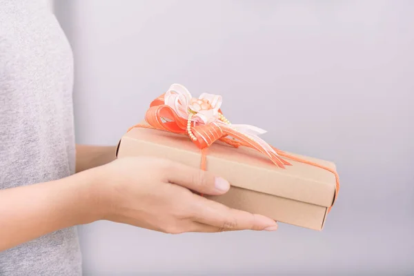 Hands holding gift box for giving in special day