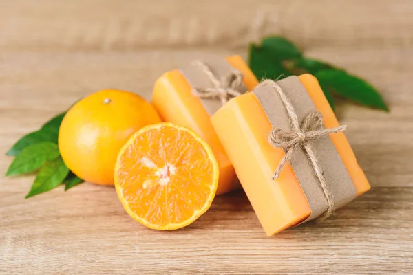 Orange soap wrapping with paper and ribbon, homemade soap