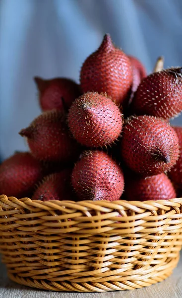 Red salacca fruit in basket, palm fruit native in Southeast Asia