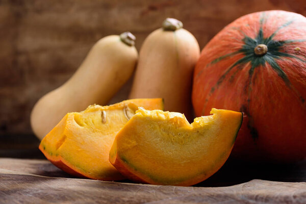 Autumn Orange Pumpkin and butternut squash on wooden background